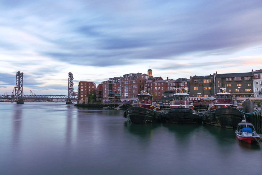 A tranquil harbor view showcasing boats in the background, reflecting the serene atmosphere of the waterfront